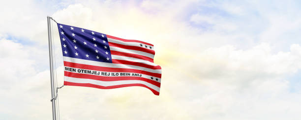 istock Bikini Atoll flag waving on sky background. 3D Rendering 1477829102