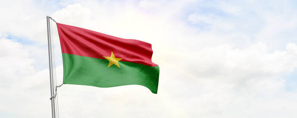 istock Burkina Faso flag waving on sky background. 3D Rendering 1477829239