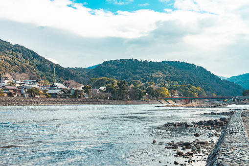 View of Uji River, houses, mountain and blue sky, Japan