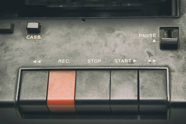 A close-up of a vintage video and audio editing control panel featuring white buttons and a faded screen. The retro design highlights the analog technology used in professional broadcasting and media production. The organized button layout emphasizes precision and functionality.