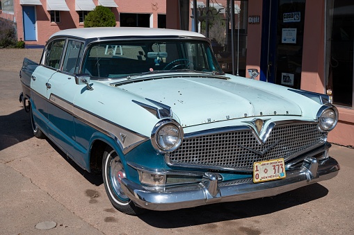 Tucumcari, United States – March 22, 2023: Front view of a classic blue american car Hudson Hornet