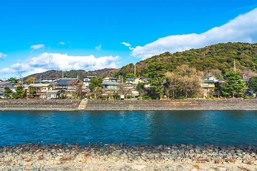View of Uji River, houses, mountain and blue sky, Japan