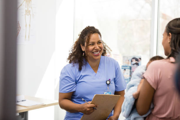 istock Smiling nurse and unrecognizable new mom talk about new baby 1477833205