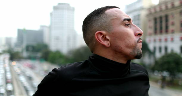 istock Pensive hispanic man thinking in downtown city 1477835295