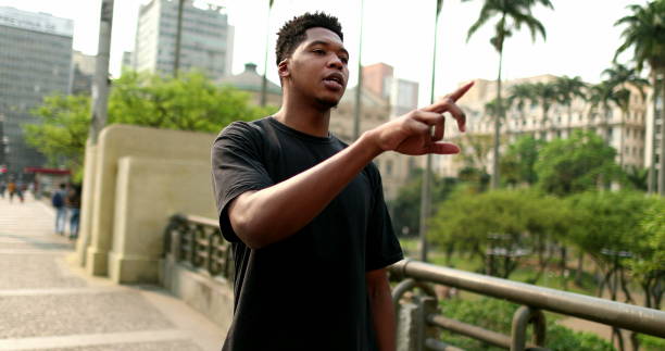 istock Cool young black man in downtown city. African guy standing outside 1477836129