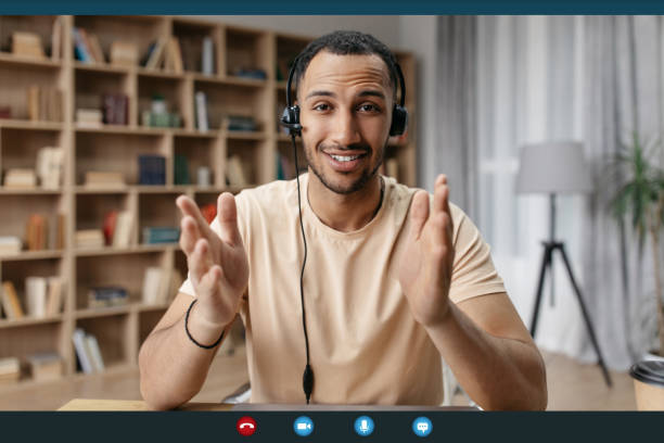 istock Web conference concept. Happy arab man making video call via laptop, talking and gesturing to webcamera, screenshot 1477838545