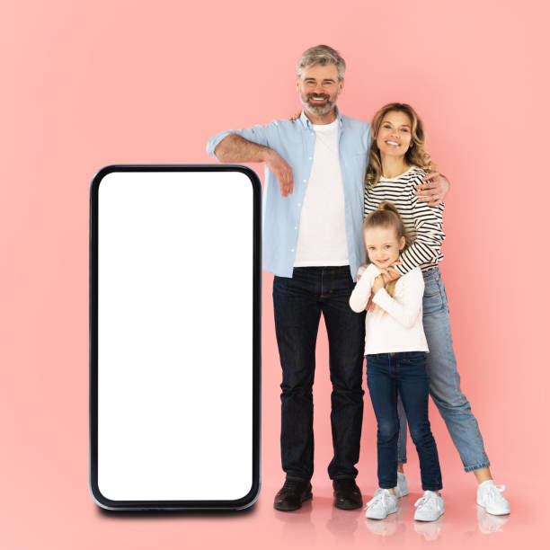 istock Family Posing With Huge Smartphone With Empty Screen In Studio 1477839847
