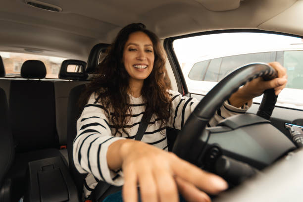 istock Arabic Driver Lady Driving Car Pushing Button In New Automobile 1477840844