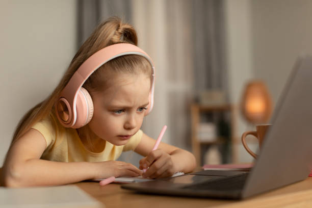 istock Little Girl Using Laptop Taking Notes Learning Online At Home 1477840854