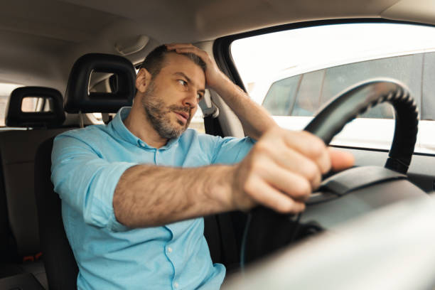 istock Displeased Driver Man Driving Car Having Problem With Automobile 1477841112