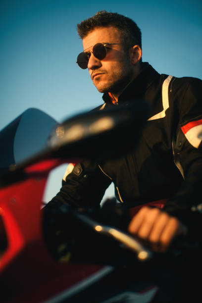 portrait of a man with sunglasses on a red race motorbike. - motorsprot imagens e fotografias de stock