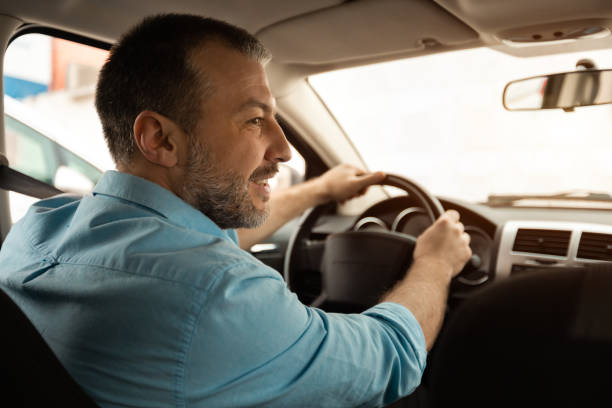 istock Confident man test driving new car in city 1477841651