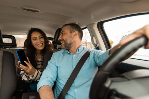 istock Couple Using Car Navigation App On Smartphone Sitting In Automobile 1477841685