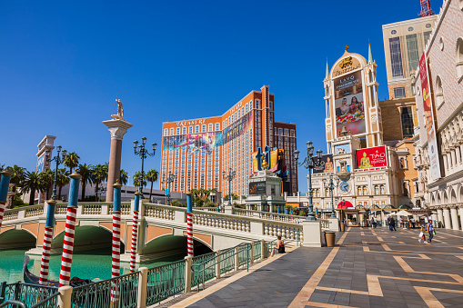 Las Vegas, United States - April 7, 2014: The Aria hotel in Las Vegas midday with clear blue sky in the background and a monorail with Aria Express on the side at the base of the image.