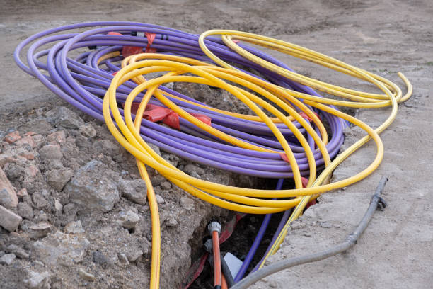 istock underground electric cable infrastructure installation. Construction site with A lot of communication Cables protected in tubes. electric and high-speed Internet Network cables are buried underground on the street 1477842314