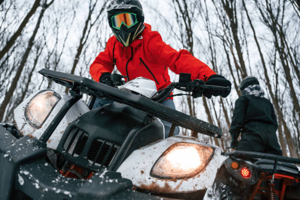 istock Two people are riding ATV in the winter forest 1477843025
