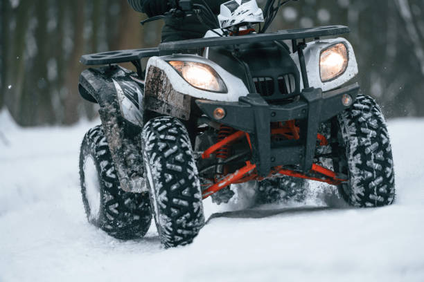 istock Snow, trees, adventure. Man is riding ATV outdoors in the winter forest 1477843059