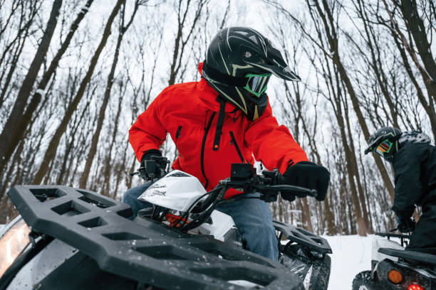 istock Two people are riding ATV in the winter forest 1477843074