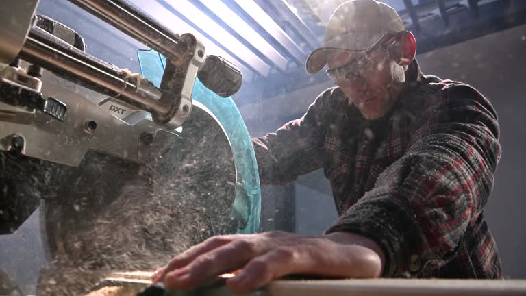 Professional Woodworker Using Powerful Wood Saw