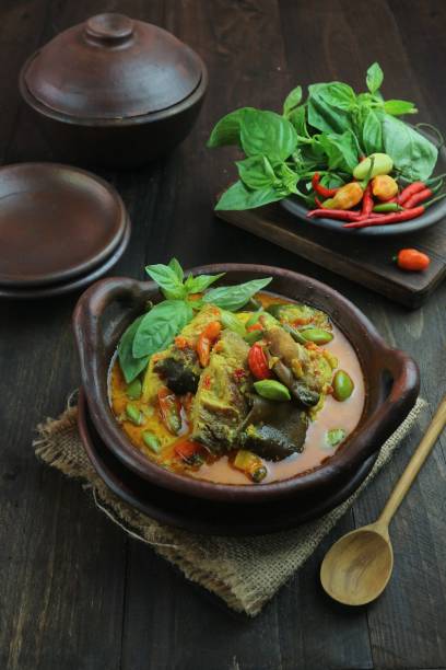 istock cooking fish with curry sauce and cayenne pepper in a clay dish 1477844493