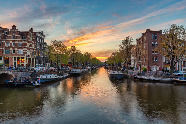 istock Amsterdam Netherlands, sunset city skyline at canal waterfront 1477845620