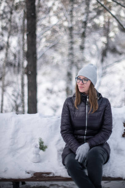 istock Woman walking in snowy winter forest 1477846155