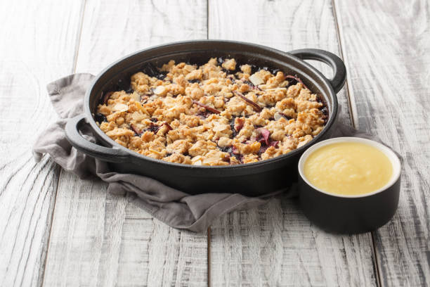 istock Smulpaj summer berry fruit pie baked with apples and blueberries served with vanilla sauce close-up in a pan. Horizontal 1477846613