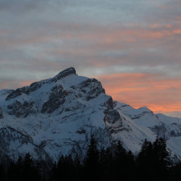 istock Pink clouds over snow covered Mount Schluchhore. 1477847028