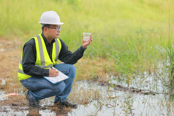 istock Environmental engineers work at water source to check for contaminants  in water sources and analysing water test results for reuse.World environment day concept. 1477849220
