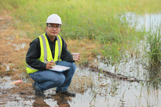 istock Environmental engineers work at water source to check for contaminants  in water sources and analysing water test results for reuse.World environment day concept. 1477849221