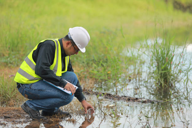 istock Environmental engineers work at water source to check for contaminants  in water sources and analysing water test results for reuse.World environment day concept. 1477849231