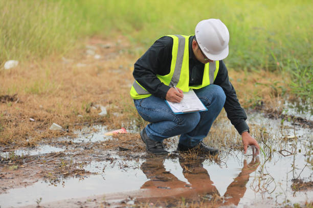 istock Environmental engineers work at water source to check for contaminants  in water sources and analysing water test results for reuse.World environment day concept. 1477849242