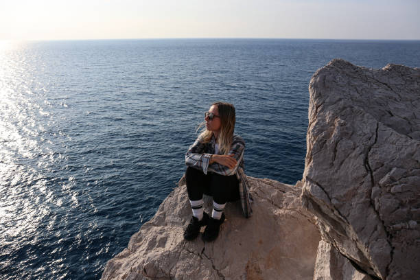 istock A woman on the cliff. 1477851085