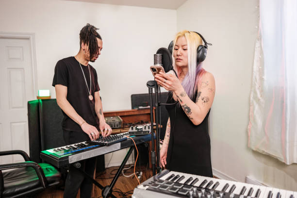istock Multi racial Musician couple  practising at home recording studio 1477853561