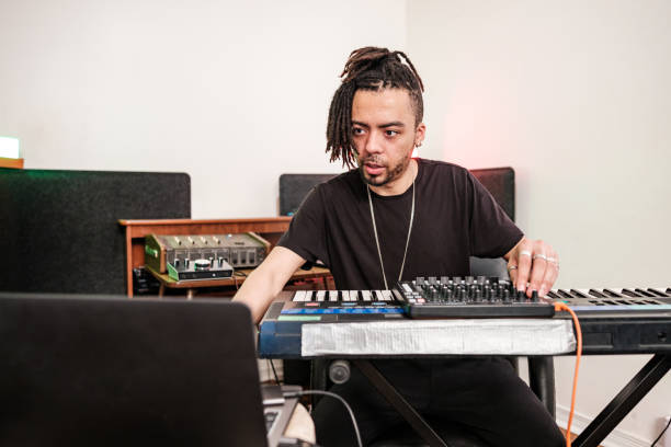 istock Male mixed race Musician practising at home recording studio 1477853620