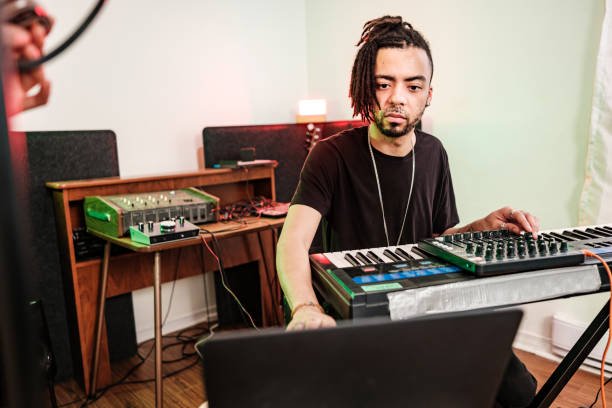 istock Multi racial Musician couple  practising at home recording studio 1477853745