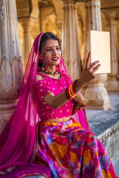 istock Young Indian girl using a digital tablet in Jaipur city 1477855493
