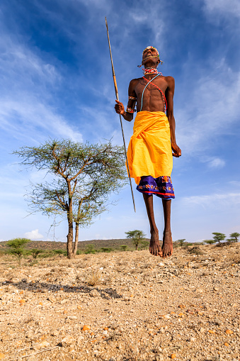 African warrior from Samburu tribe performing a traditional jumping dance, central Kenya. Samburu tribe is one of the biggest tribes of north-central Kenya, and they are related to the Maasai.