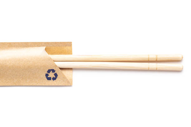 disposable bamboo chopsticks in recycle envelope on white background