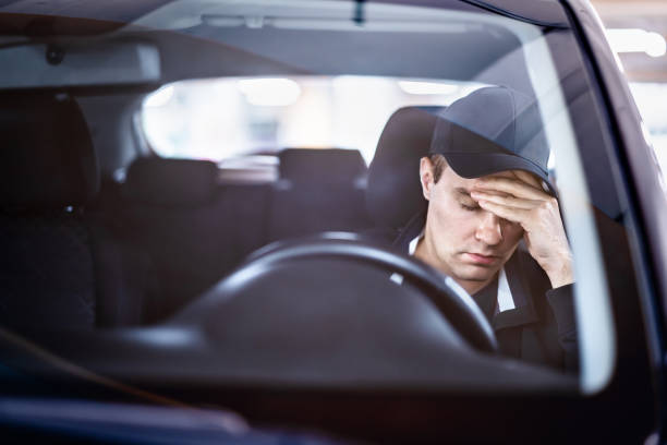 Sad man in car. Accident in traffic. Tired sleepy driver. Sick with headache or migraine. Anxiety, stress, despair or depression. Exhausted after driving. Problem with insurance. stock photo