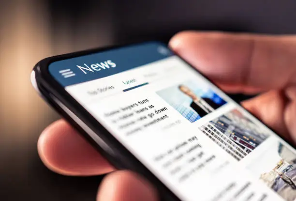 Photo of News online in phone. Reading newspaper from website. Digital publication and magazine mockup. Press feed with latest headlines in digital web portal.
