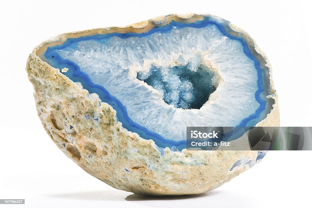 Close-up of a blue agate with hole in the middle, on white blue shining agate with hole on white ground Gemstone Stock Photo