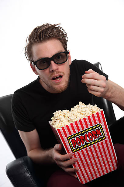 istock Amazed man in 3D-glasses with a popcorn bucket 147786567
