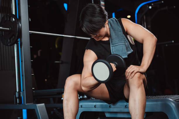 istock Male working out Bodybuilder with dumbbell weights at the gym.man bodybuilder doing exercises with dumbbell. training sport healthy lifestyle bodybuilding, Athlete builder muscles lifestyle. 1477865914