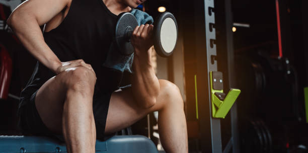 istock Male working out Bodybuilder with dumbbell weights at the gym.man bodybuilder doing exercises with dumbbell. training sport healthy lifestyle bodybuilding, Athlete builder muscles lifestyle. 1477865983