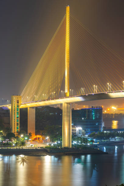 colorful night view of bai chay bridge, connecting two parts of ha long city, hon gai city and bai chay city through cua luc bay. - ha gai imagens e fotografias de stock