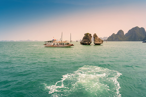 View of Ha Long Bay, Quang Ninh province, Vietnam; with a lot of limestone islets and cruise ships; on a blue sky summer day.  Travel and landscape concept.