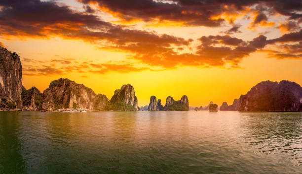 blick auf die ha long bucht, provinz quang ninh, vietnam; mit vielen kalksteininseln und kreuzfahrtschiffen; an einem sommertag mit blauem himmel - halong bay stock-fotos und bilder