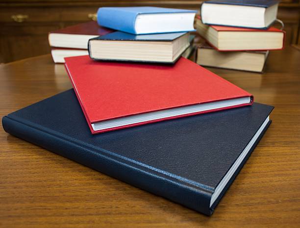 istock Many different sized colored and shaped books on wood table 147786738