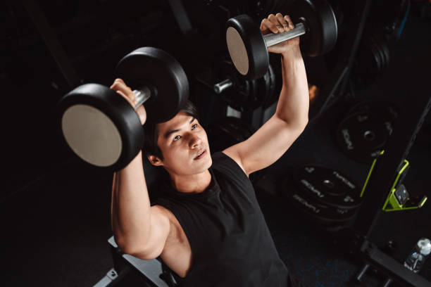 istock Male working out Bodybuilder with dumbbell weights at the gym.man bodybuilder doing exercises with dumbbell. training sport healthy lifestyle bodybuilding, Athlete builder muscles lifestyle. 1477869820